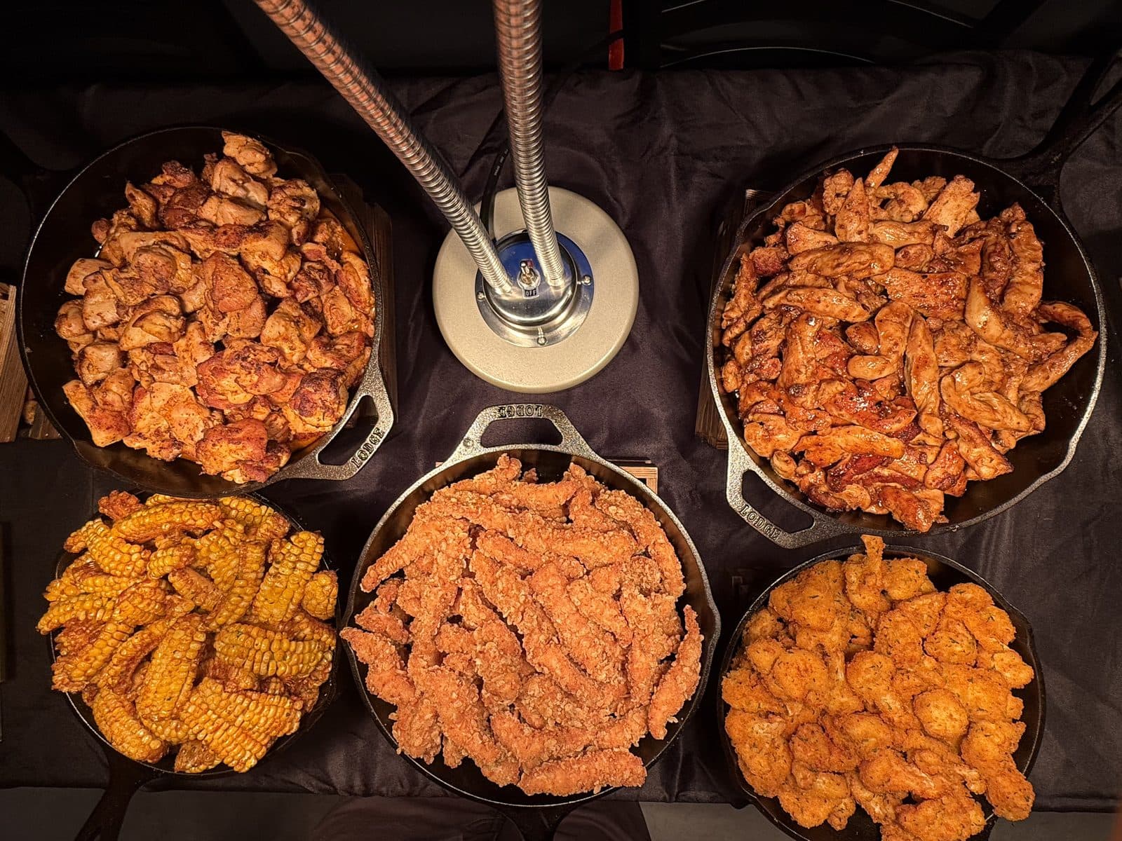 Cast-iron skillets of grilled and crispy chicken at BHI Thursdays