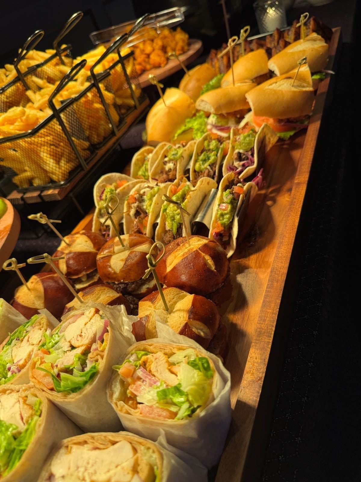 Party boards with tacos, sliders, wraps, and fries at BHI Thursdays in Brooklyn