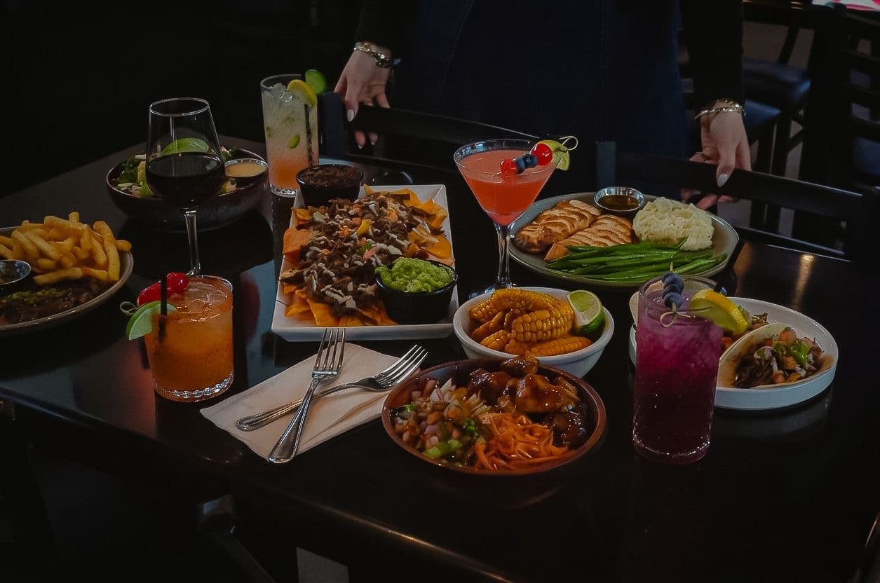 Kosher cocktails and dinner dishes on a table at BHI Thursdays